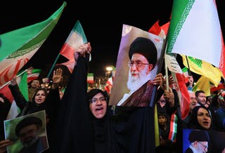 People take part in an anti-U.S. and anti-Israel rally at Enghelab Square in Tehran
